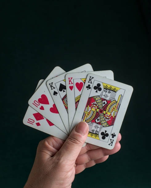 Blackjack dealer at live table dealing cards to multiple players